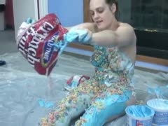A white bitch with a plump breast and a dilettante pours crunchies on herself.